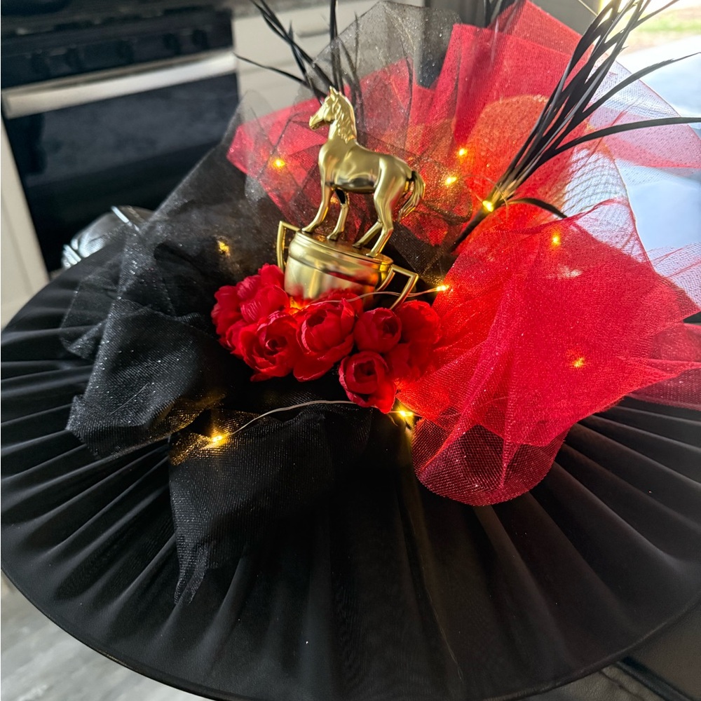 Elegant Black and Red Hat with Gold Horse Accent